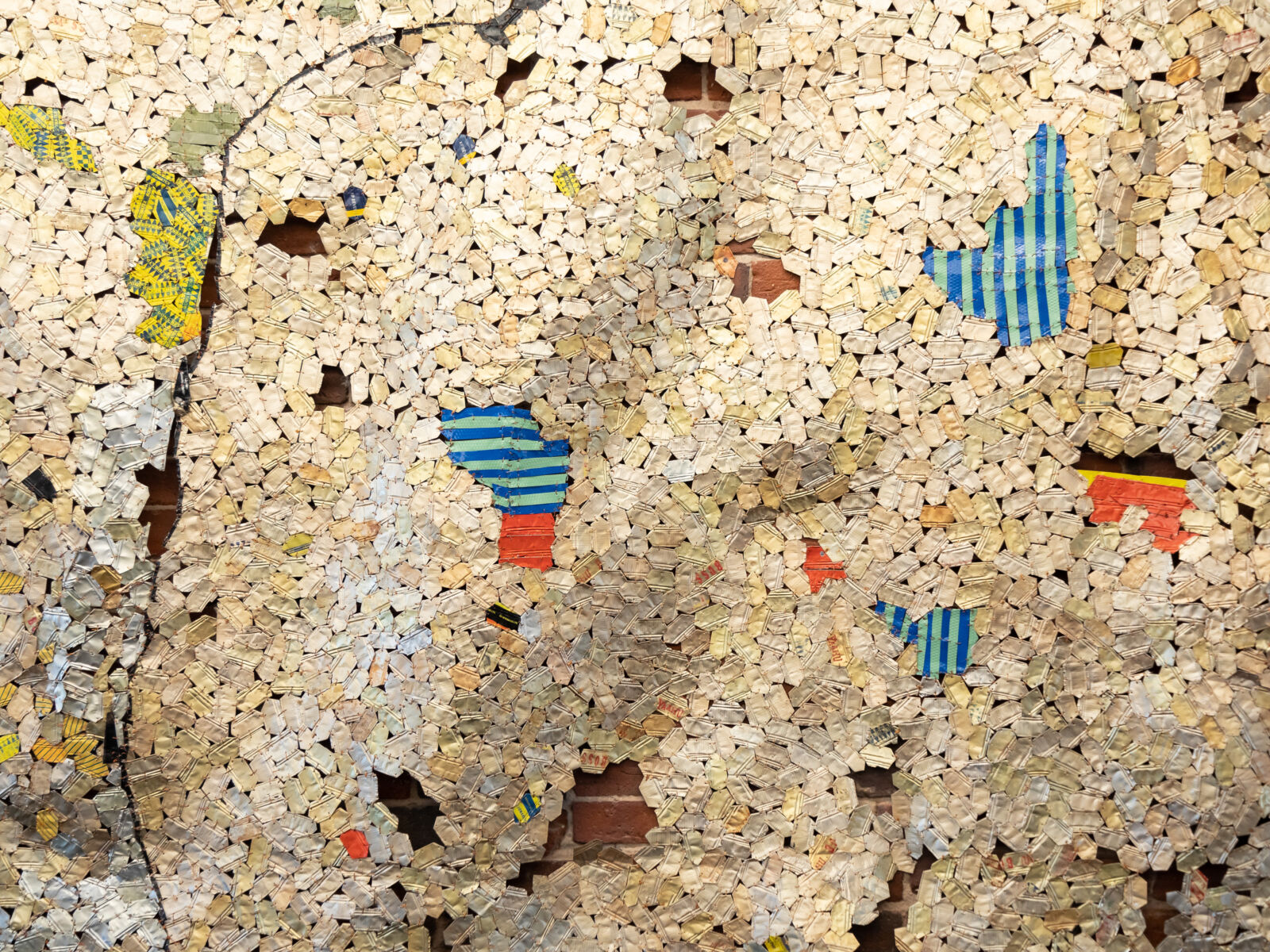 A piece of artwork made of aluminum and copper wire by Ghanan artist, El Anatsui.