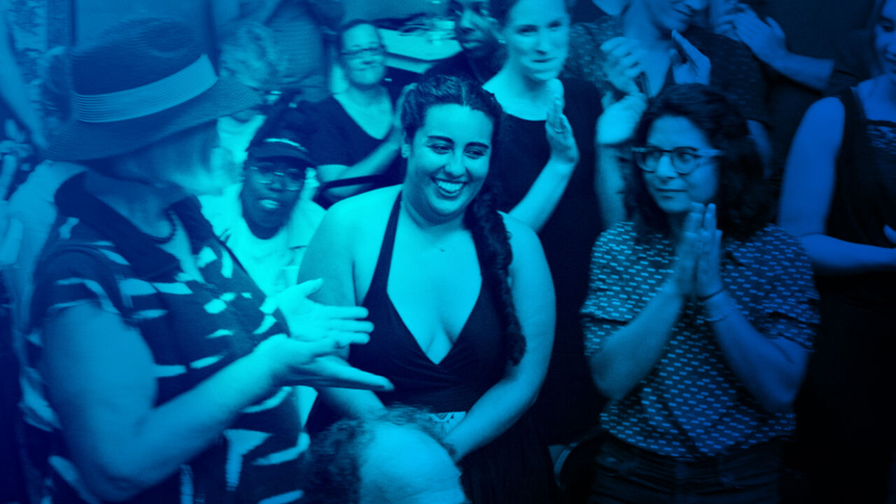 A group of Theater Offensive artists smile after a production.