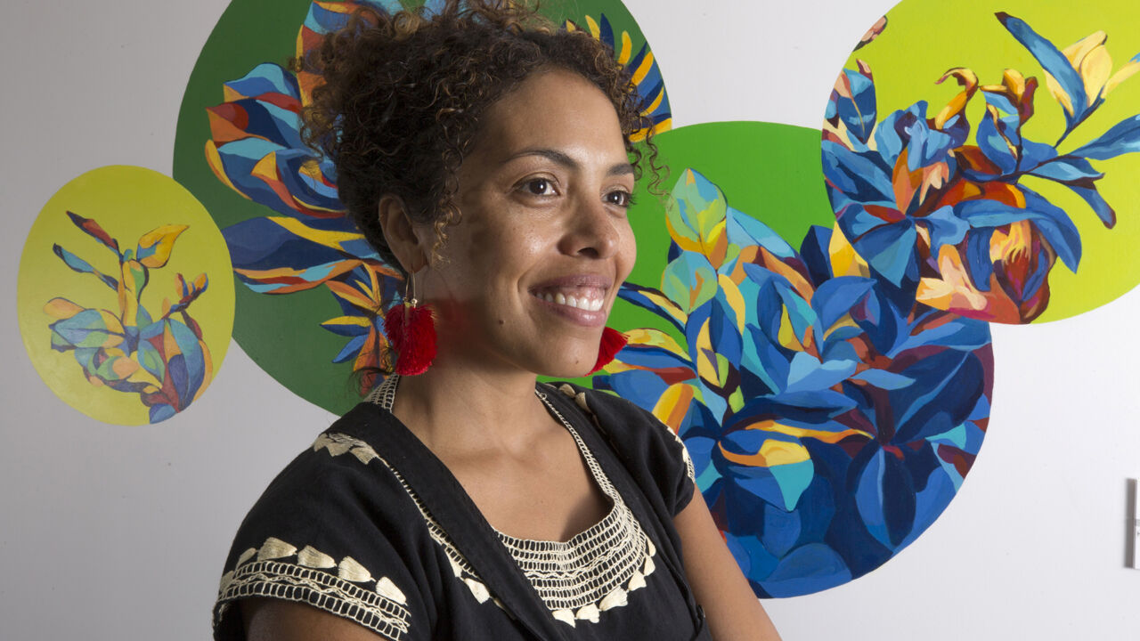 Artist Silvia Chavez poses with her mural.