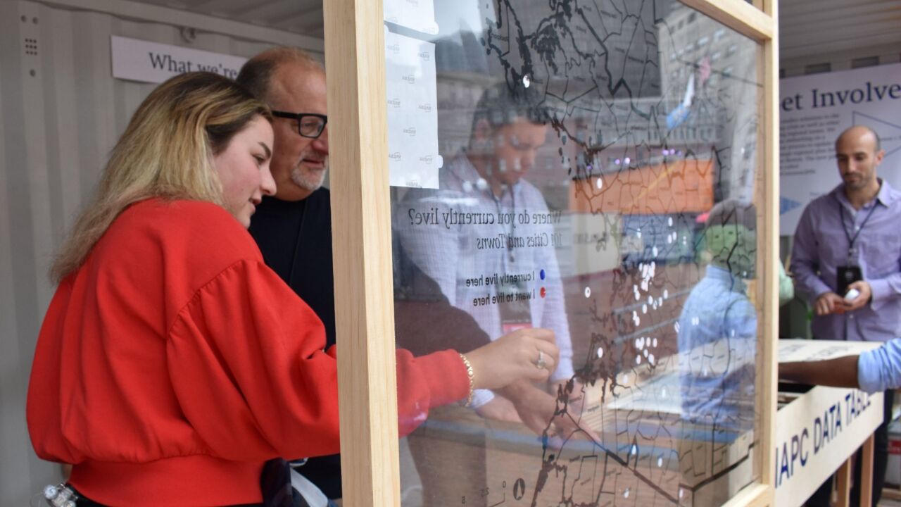 A man and a woman look at a map of Boston together.