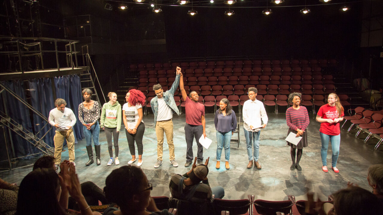 Teenagers take a bow on the stage.