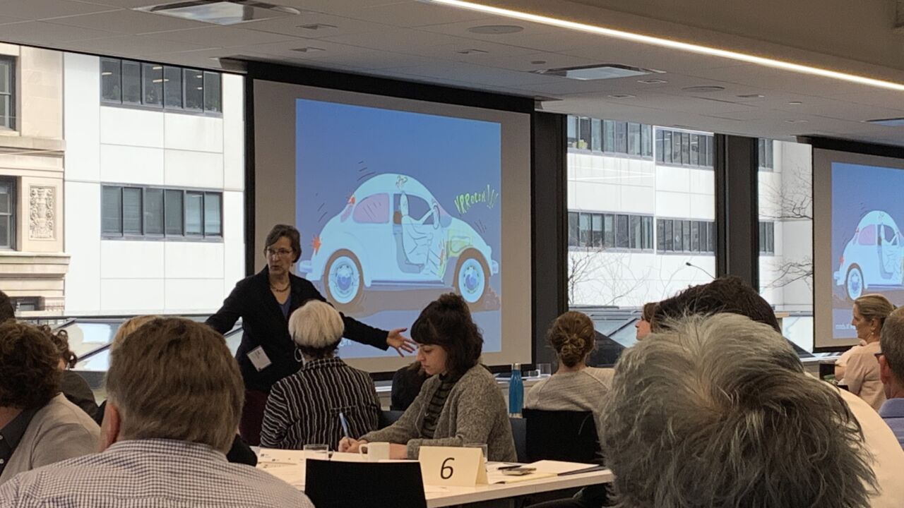 Coach from Minds at Work in front of a group of people in a classroom style.