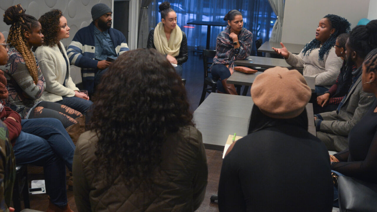 Teachers listen to each other in a group.