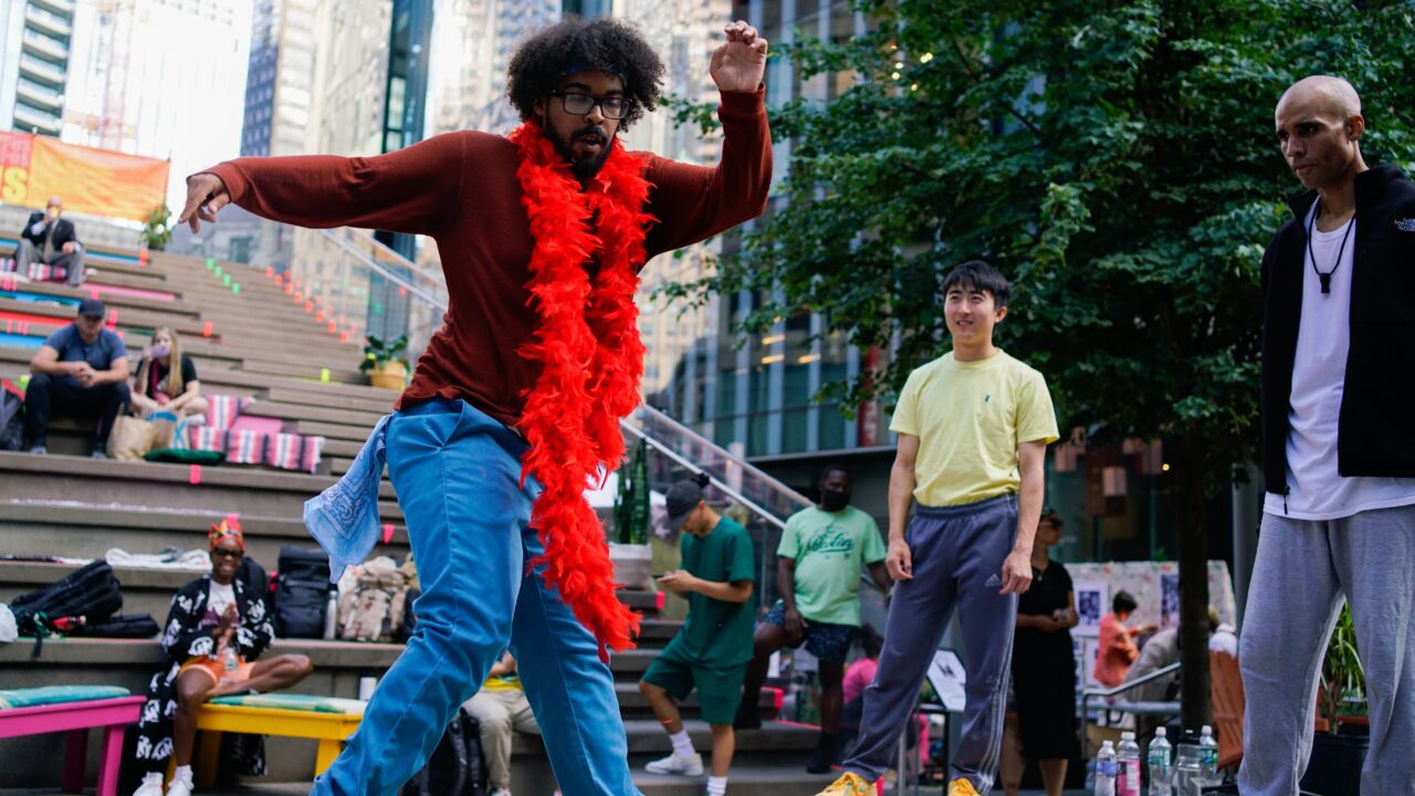 A man dances on the street in downtown Boston.
