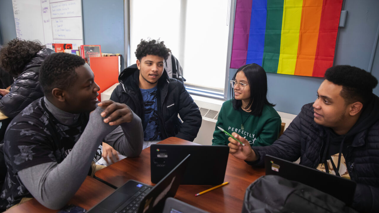 Group of students collaborating in a high school classroom.
