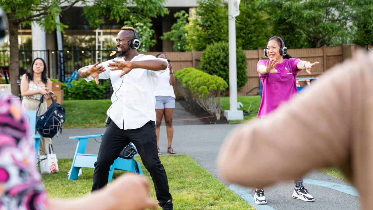A group of people outside dancing.