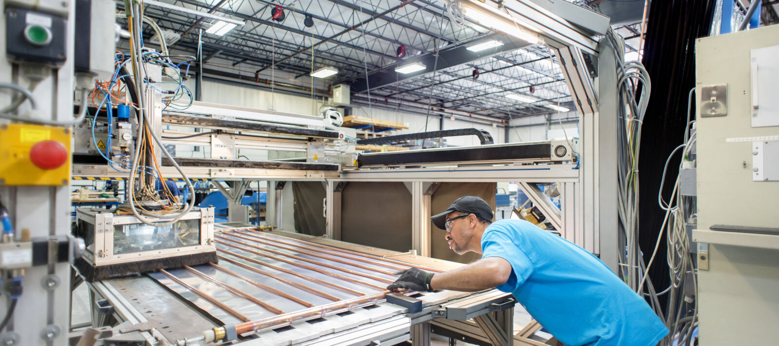 Man in a workshop making a solar panel.