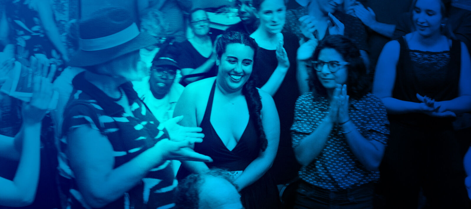 A group of Theater Offensive artists smile after a production.