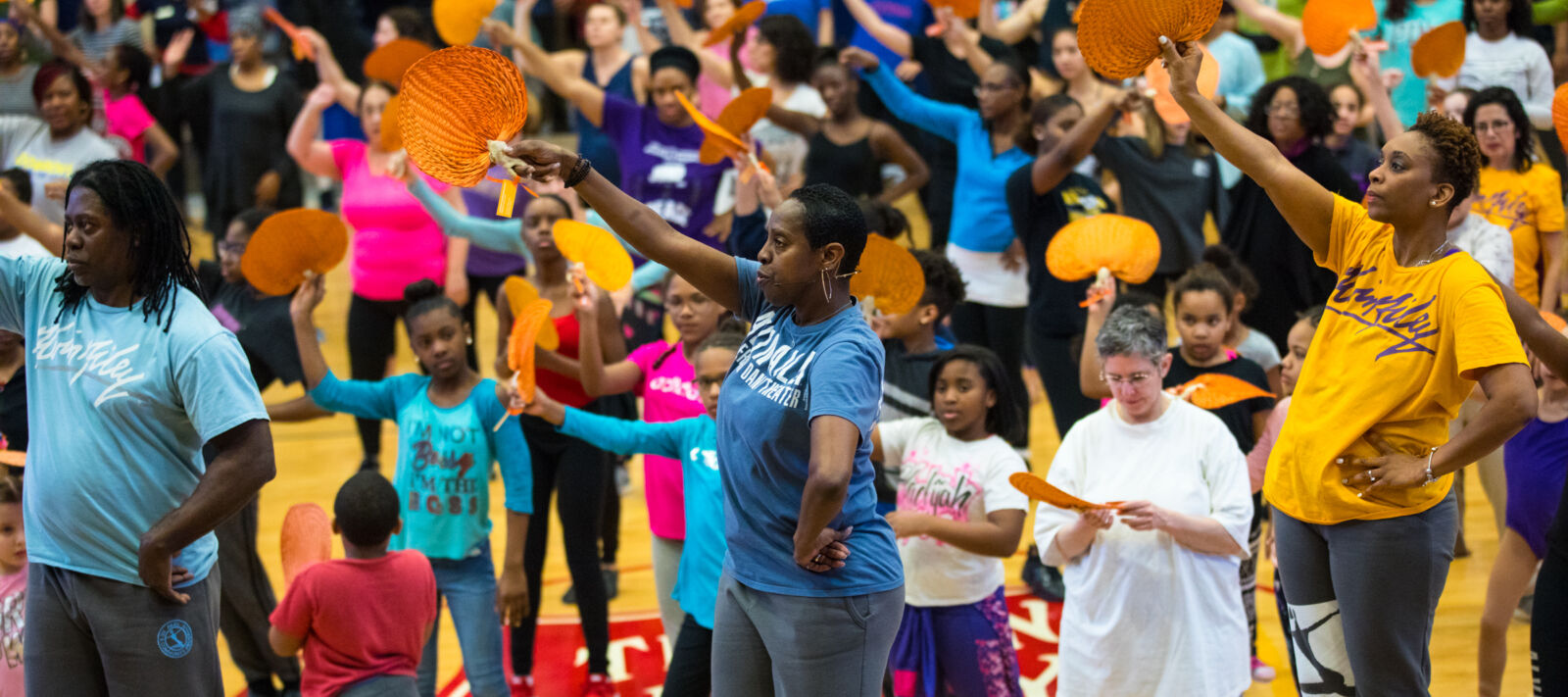 Young kids learn from Alvin Ailey dancers.