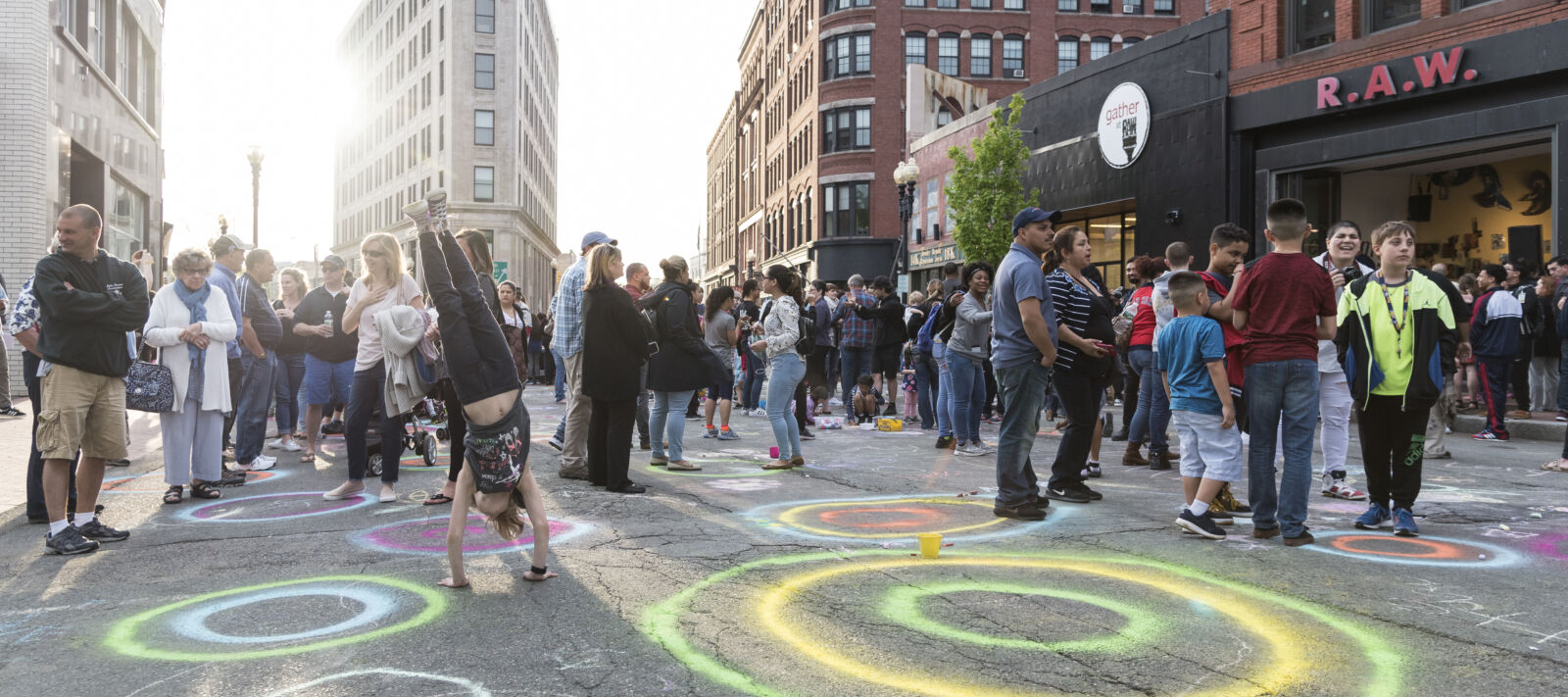 People celebrate outside and make art at a block party.