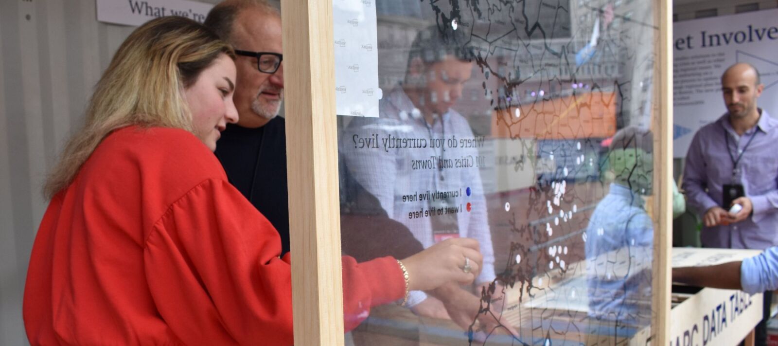 A man and a woman look at a map of Boston together.
