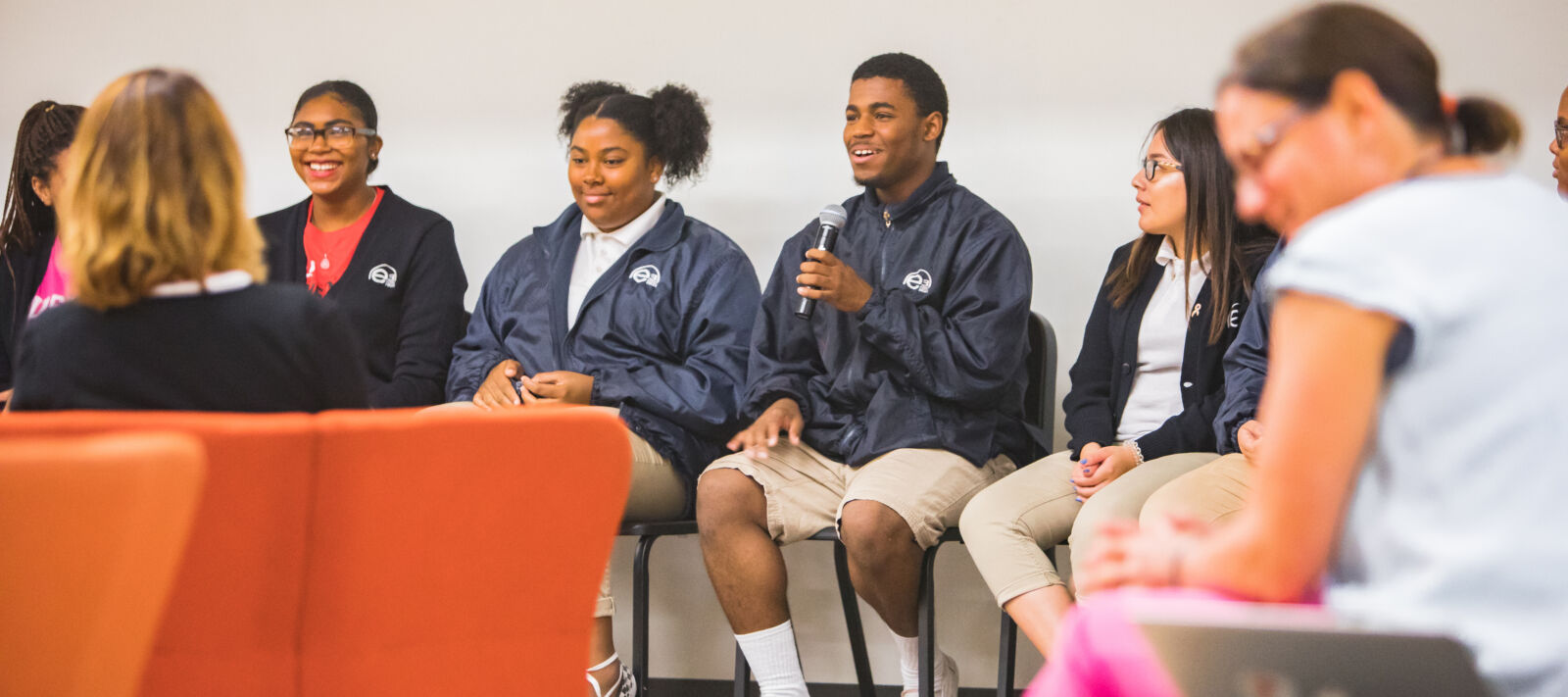 Students talk on a panel.