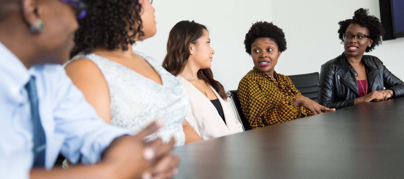 People sit at a table and have a conversation.