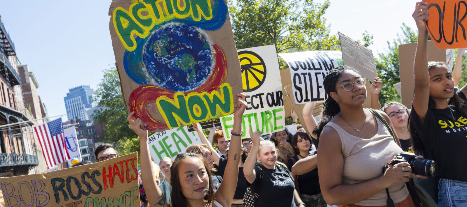 Young people march and hold signs for climate change