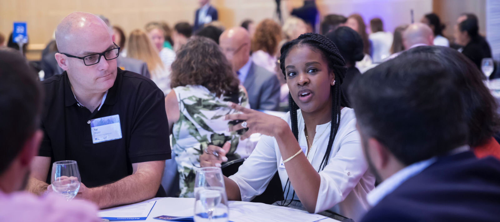 A woman speaks at a round table.