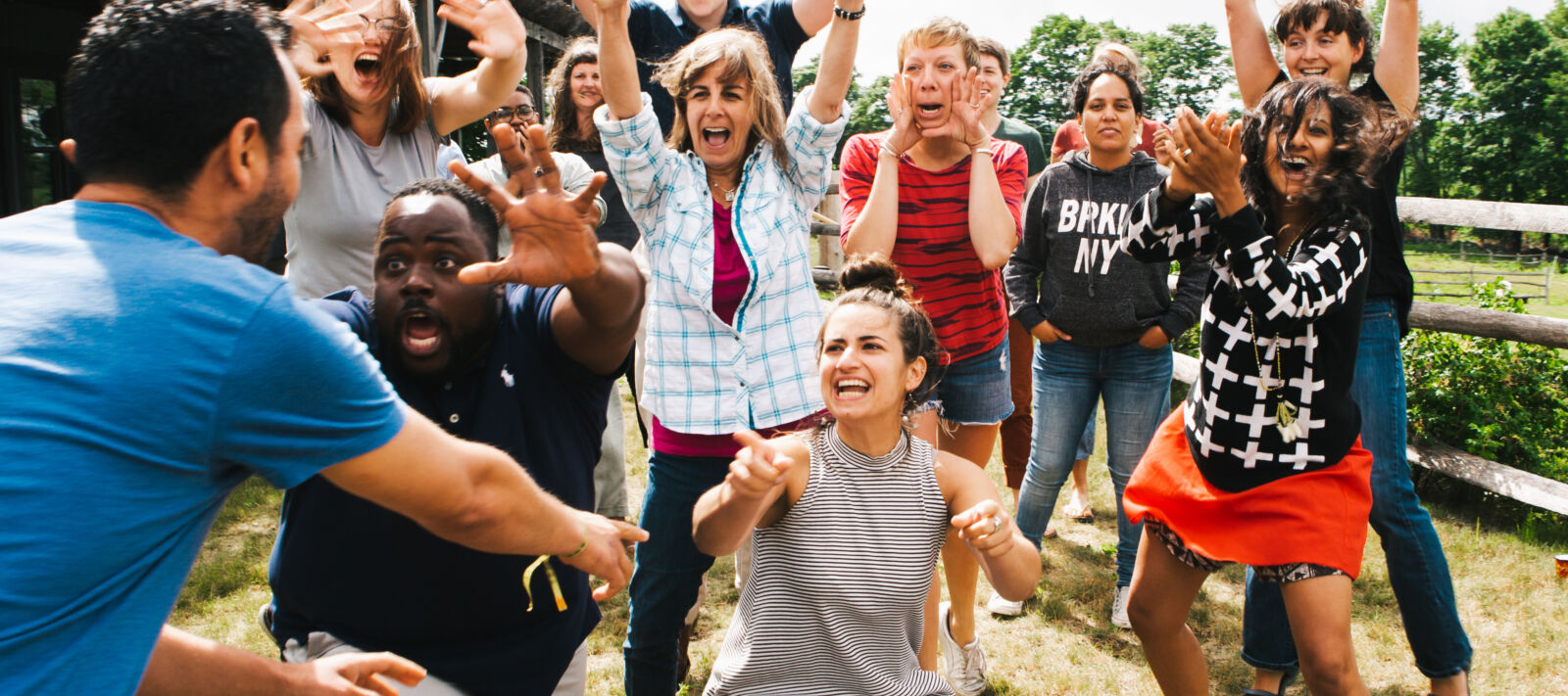 A group of excited people with different facial expressions as they play sharades.