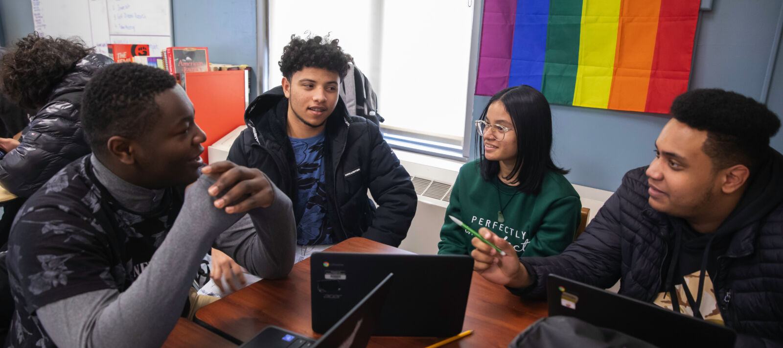 Group of students collaborating in a high school classroom.