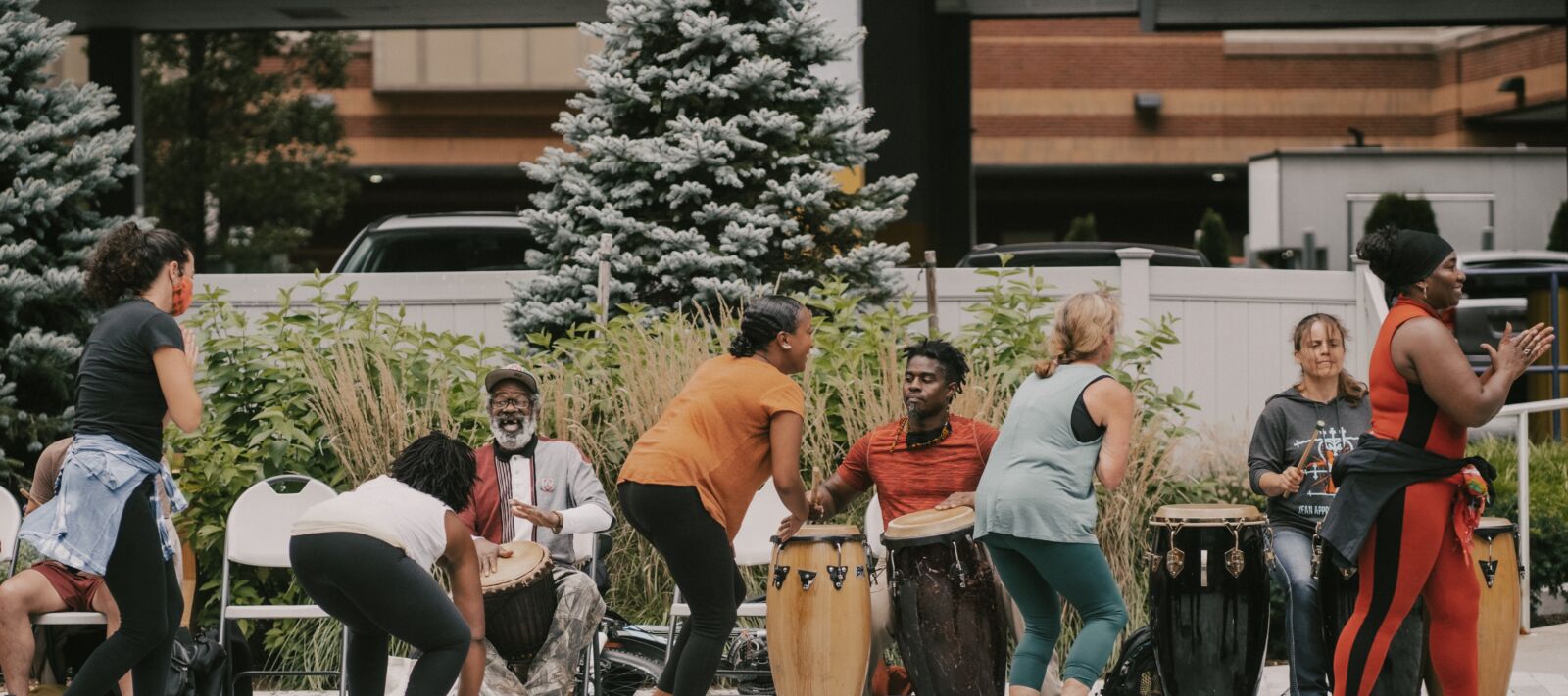 People making music in an outdoor public space using drums