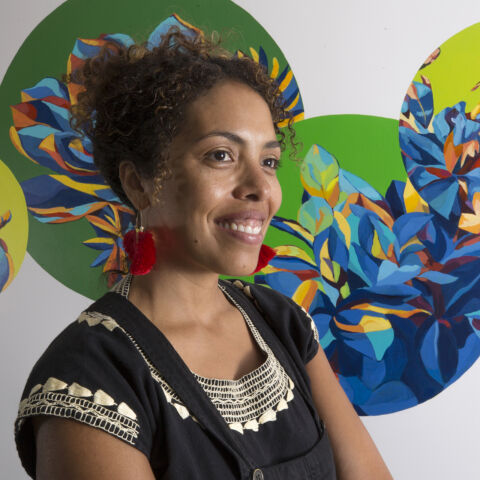 Artist Silvia Chavez poses with her mural.