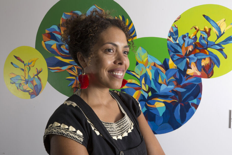 Artist Silvia Chavez poses with her mural.