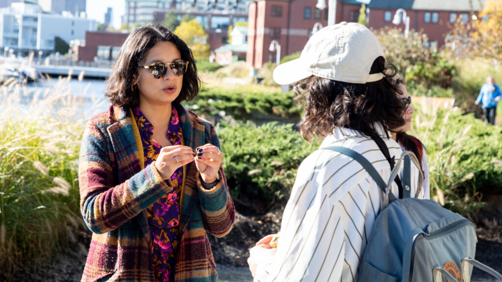Two women talking in Chelsea, Massachusetts along the waterfront. They are engaged in serious discussion on a bright, sunny day.